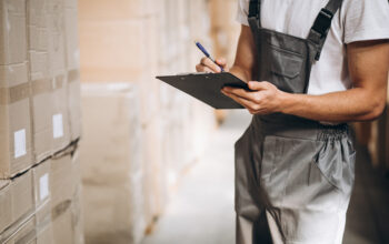 Young man working at a warehouse with boxes