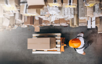 Young man working at a warehouse with boxes