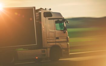 Road Transportation by Truck Concept Photo. Speeding Euro Truck on the European Highway.